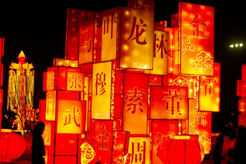 large lighted lanterns with various asian writing in the night