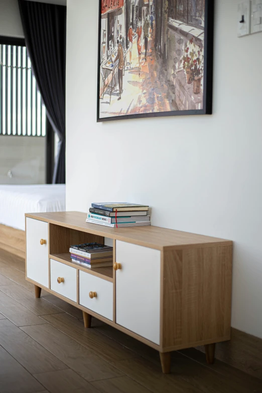 a very neat looking bedroom with a tv cabinet