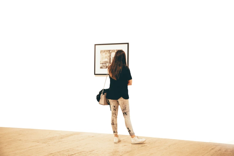 a woman standing in front of a picture looking up at the sky