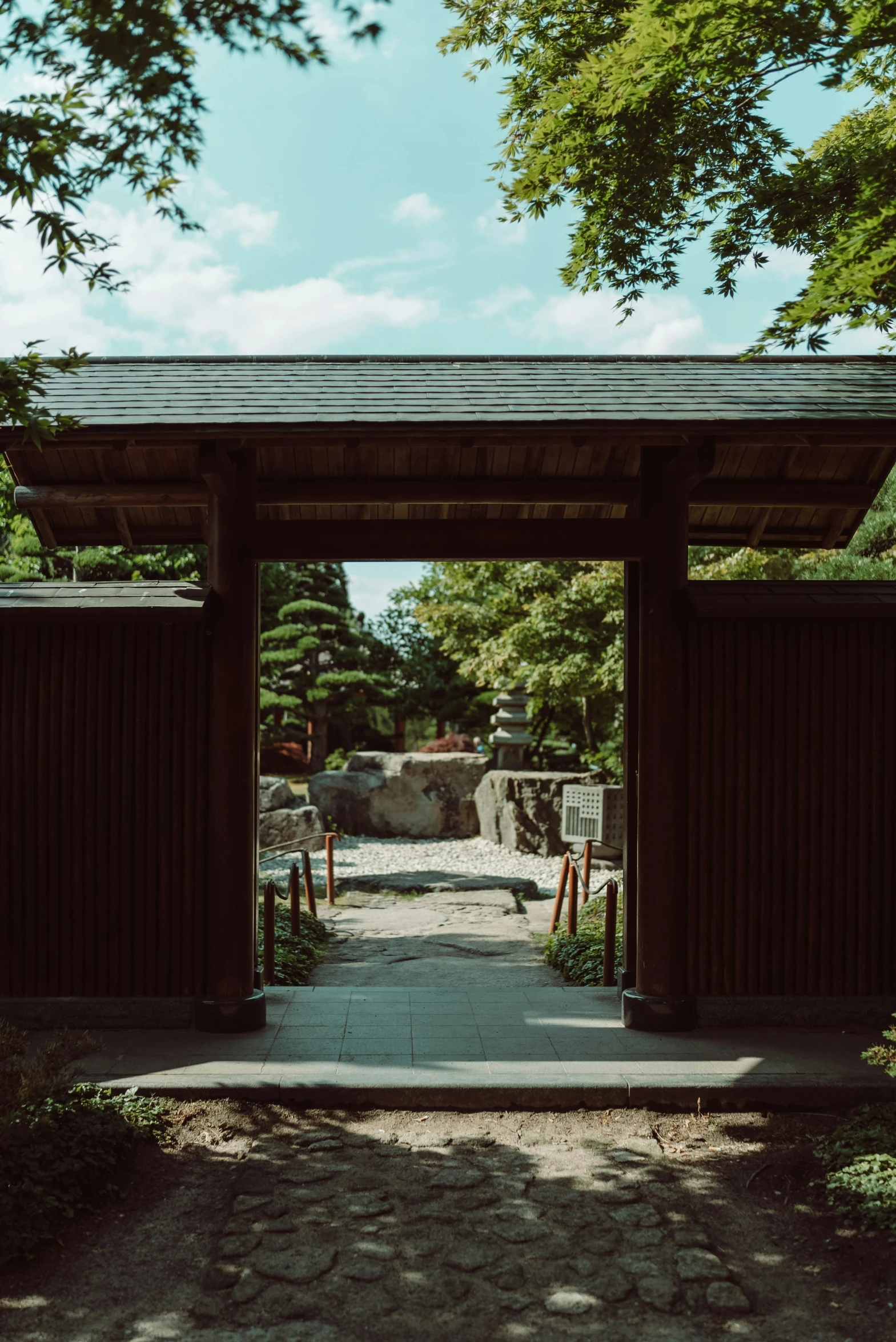 the walkway is lined with trees and benches