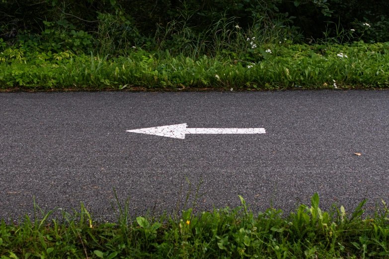 an arrow painted on the ground is pointing towards another direction