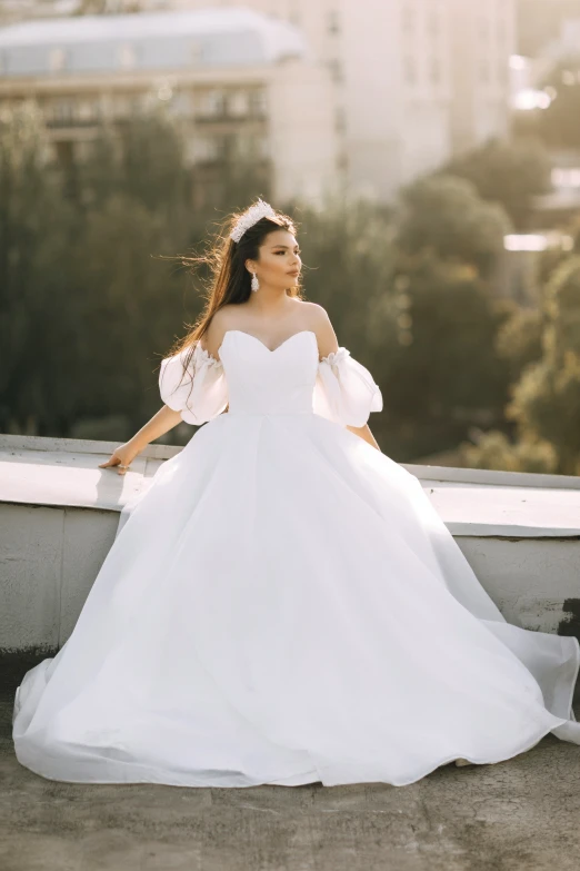 a beautiful young woman wearing a white dress in a balcony