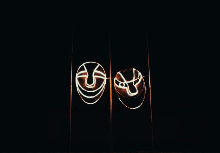 two smiley faces with the lights behind them