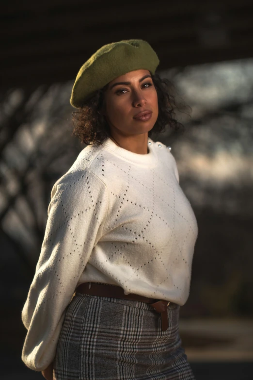 a woman in plaid skirt and green hat poses for a picture