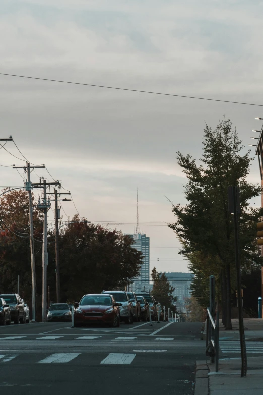 many cars are lined up at the intersection of an empty street