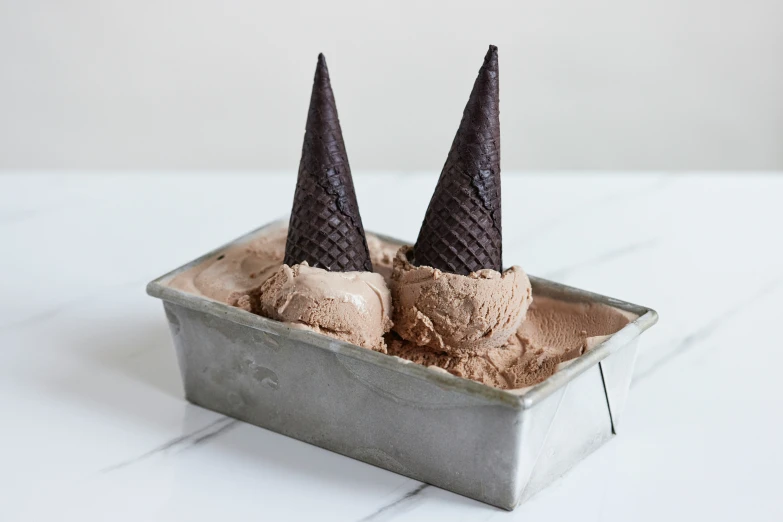 some ice cream in some tins on a table