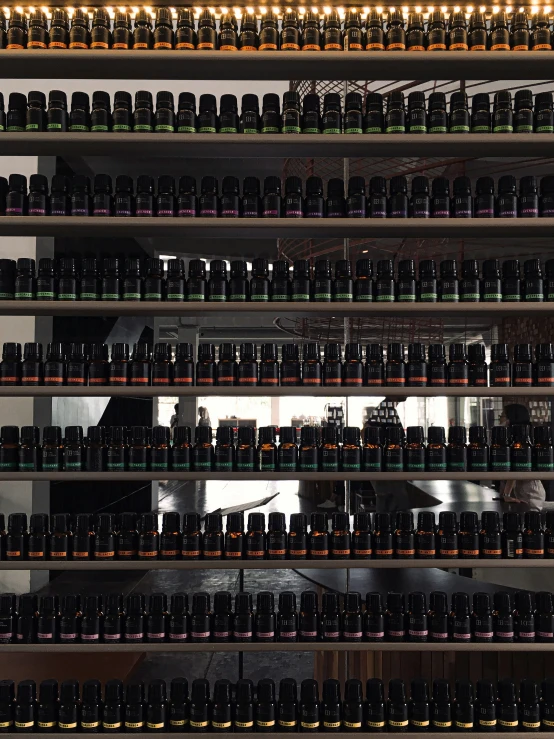 there is a large amount of bottles on shelves