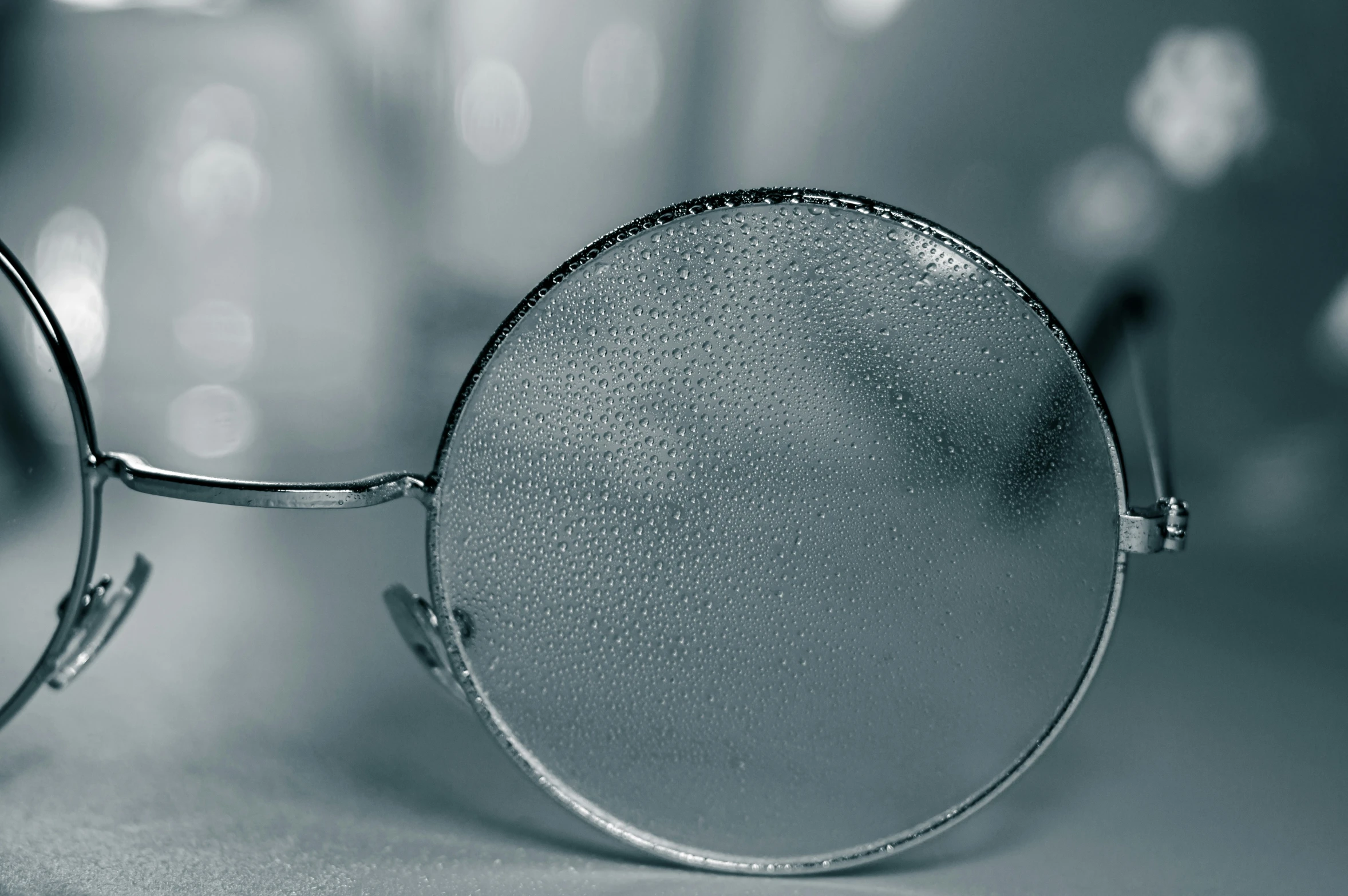 a pair of round glasses is resting on a table