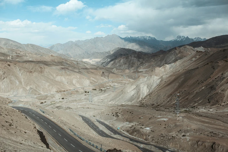 this view shows the mountains that are mostly brown and have blue water