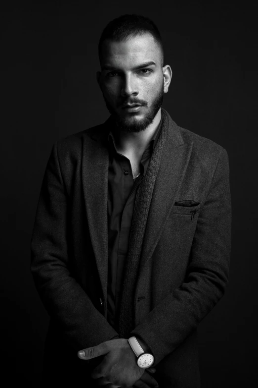 a young man posing for a black and white po