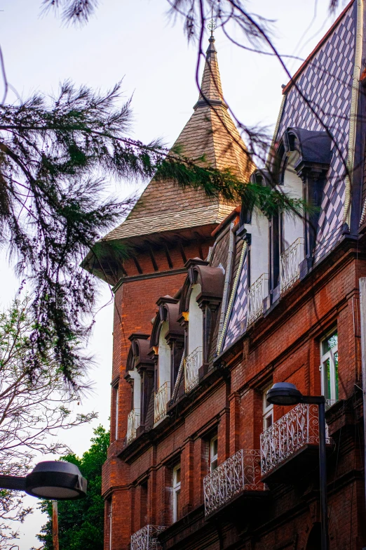 the front of an old brick building with balconies and windows