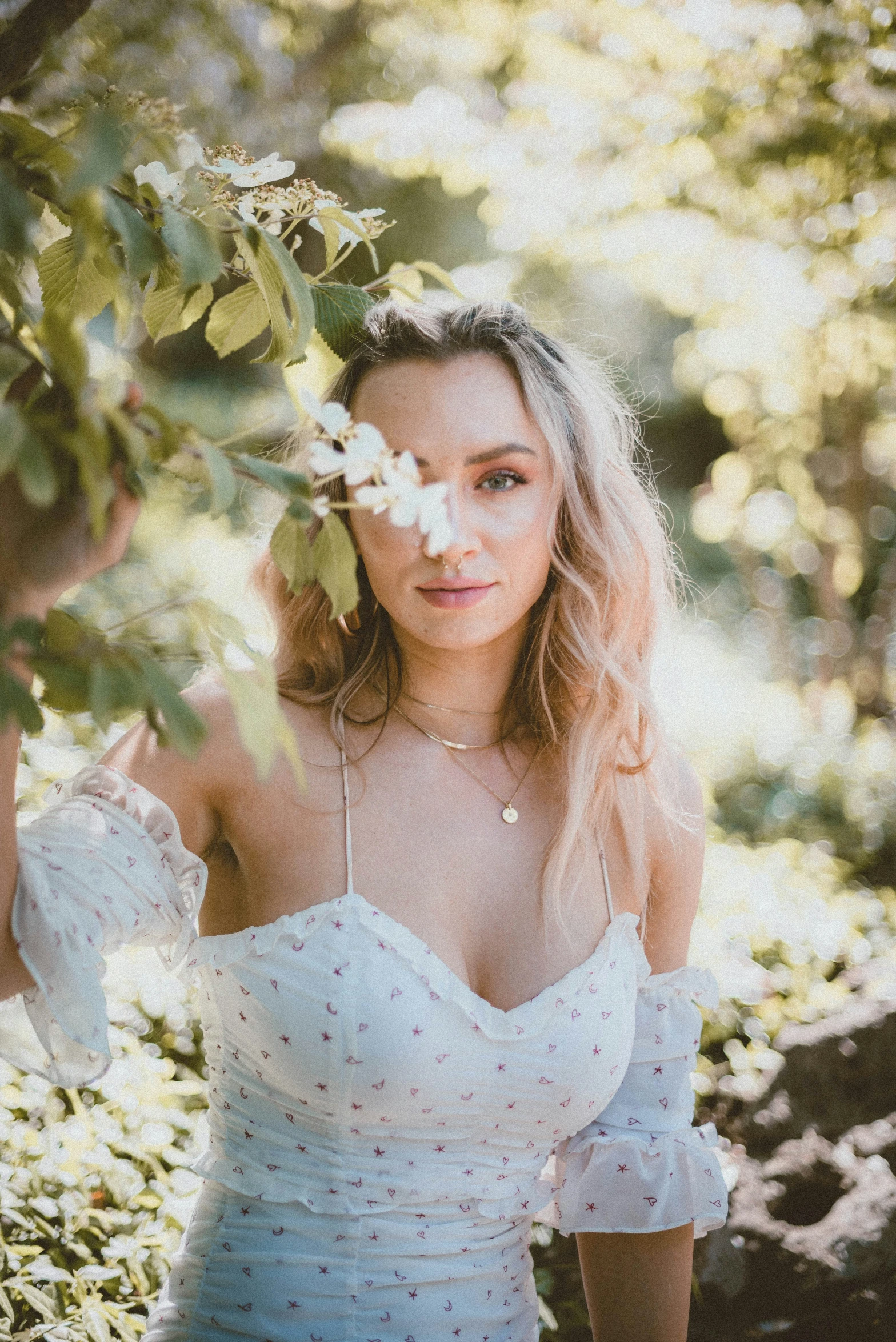 a woman wearing a white wedding dress in a field