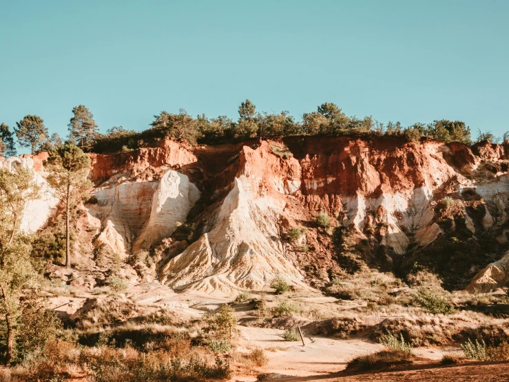 the desert has different colored mountains and trees on it