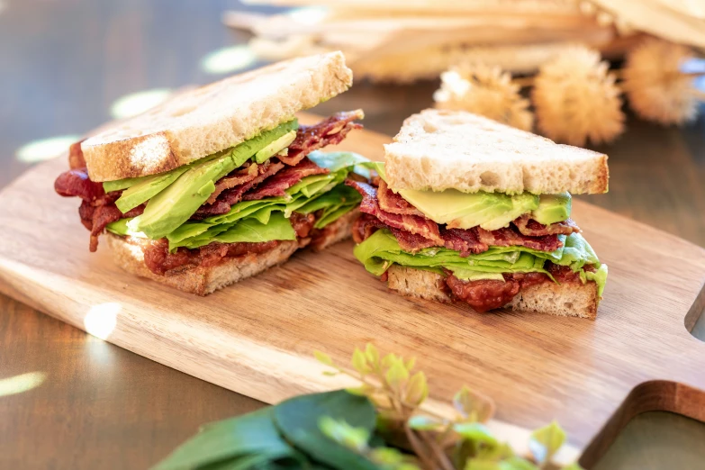 a large sandwich cut in half on a  board