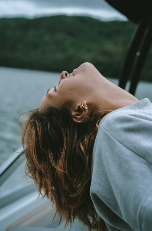 woman laying head on shoulder of car