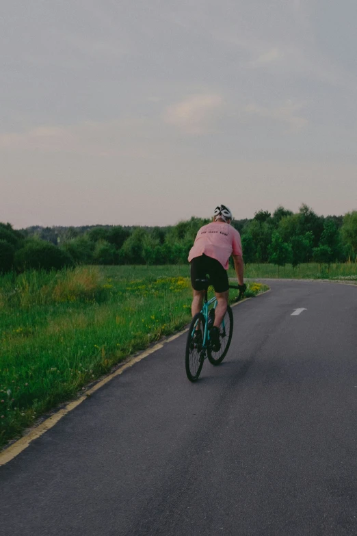 a person riding a bicycle on a country road