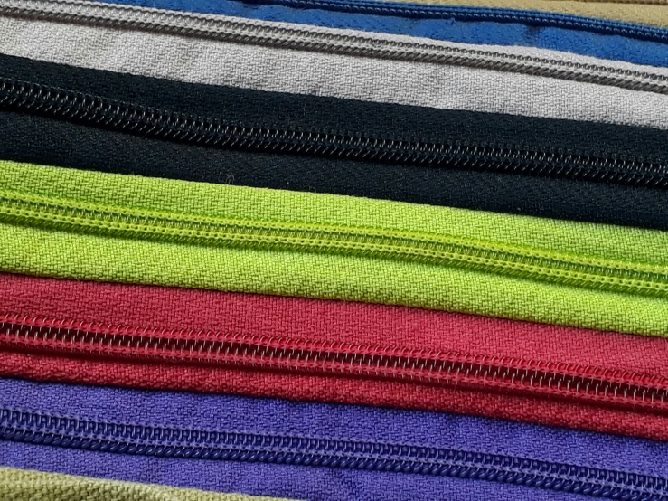 multiple zippers in different colors are stacked on top of each other