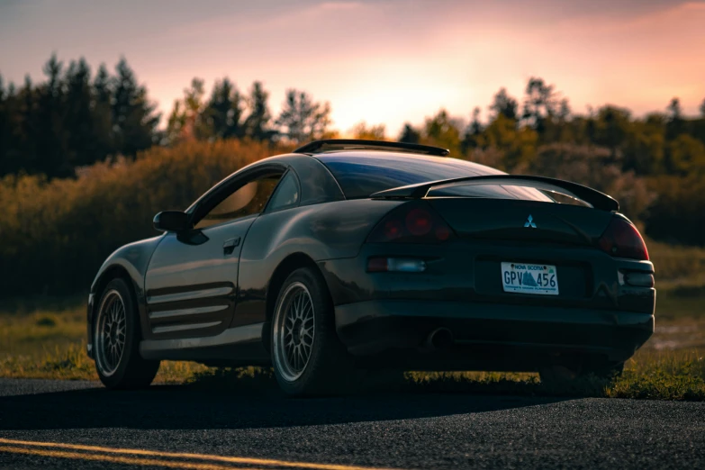 a car parked on the side of the road at sunset