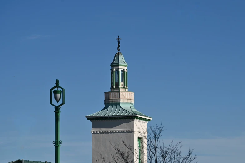 a tall tower on top of a building near a street light