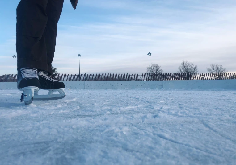 a man is rollerskain down a snowy road