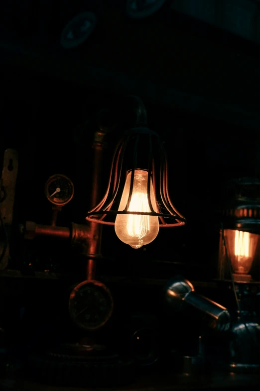 a hanging lamp with bulbs and gauges in the dark