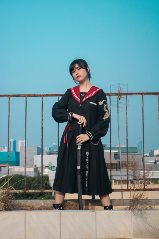 a  dressed in period garb poses on a fence