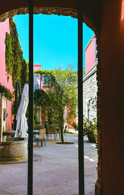 a courtyard through some doors at a building