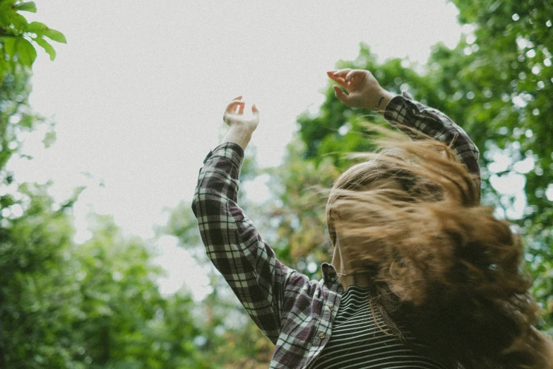 a woman in a shirt is reaching for soing