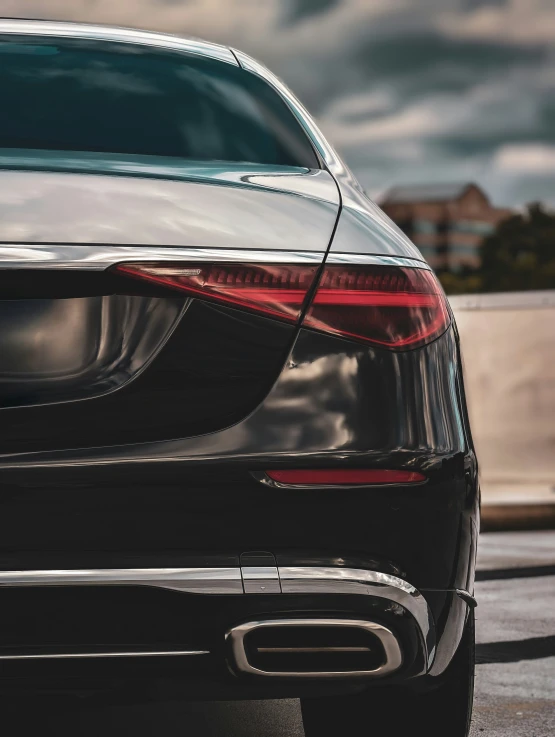 a black and silver car is in an urban setting