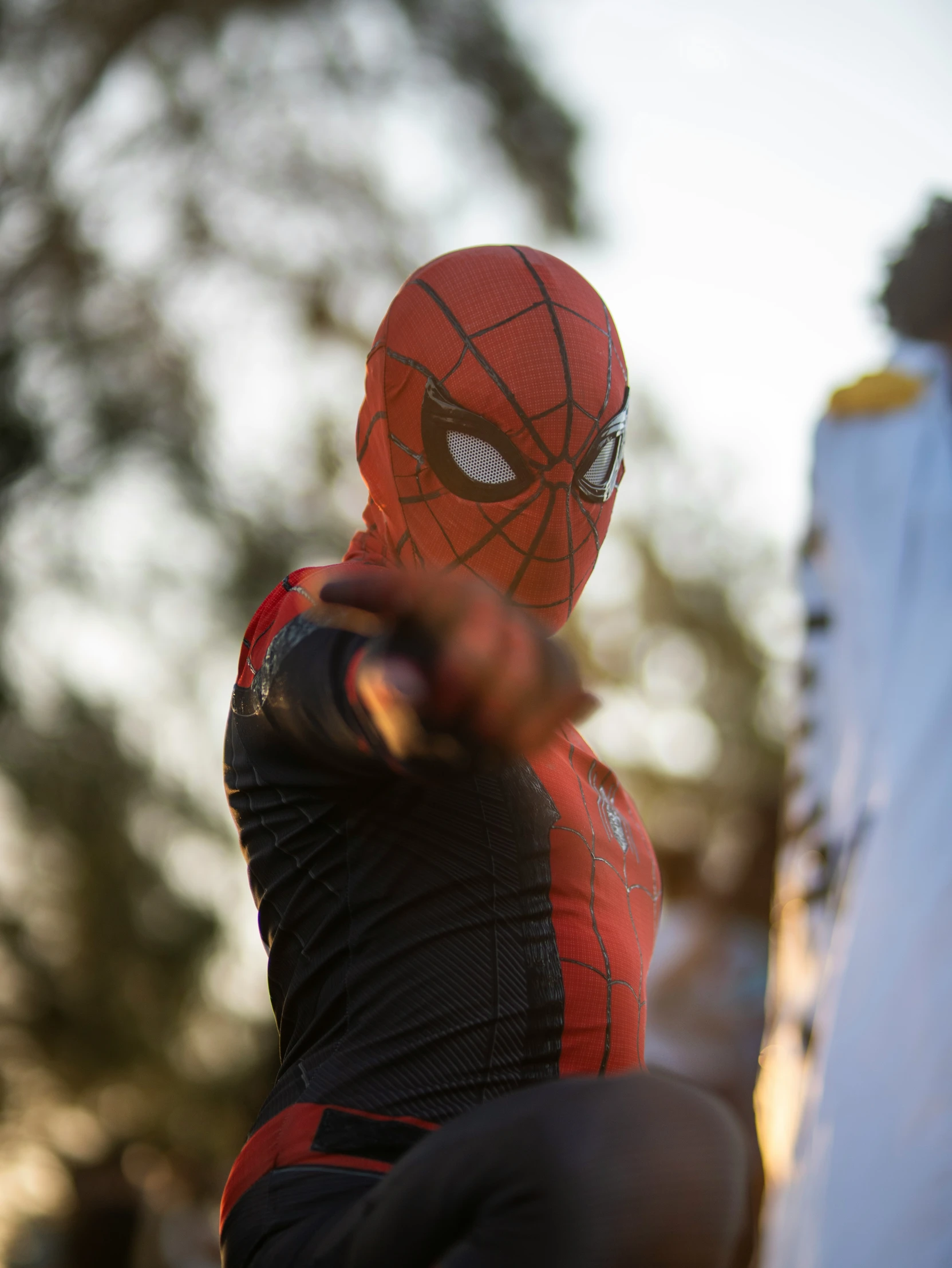 a person is dressed as a spider man throwing a baseball