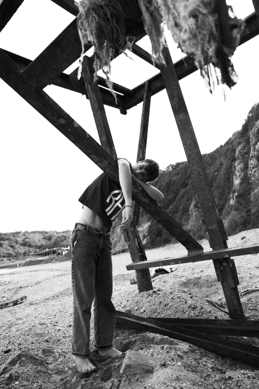 a black and white po of a person standing on the beach