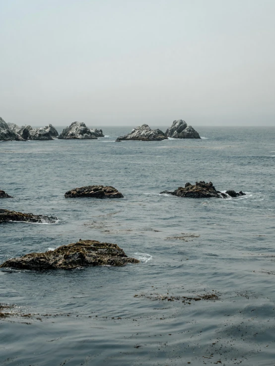 an ocean that has a lot of rocks out in it