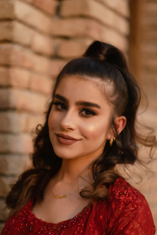 a woman wearing red smiling and looking off to the side