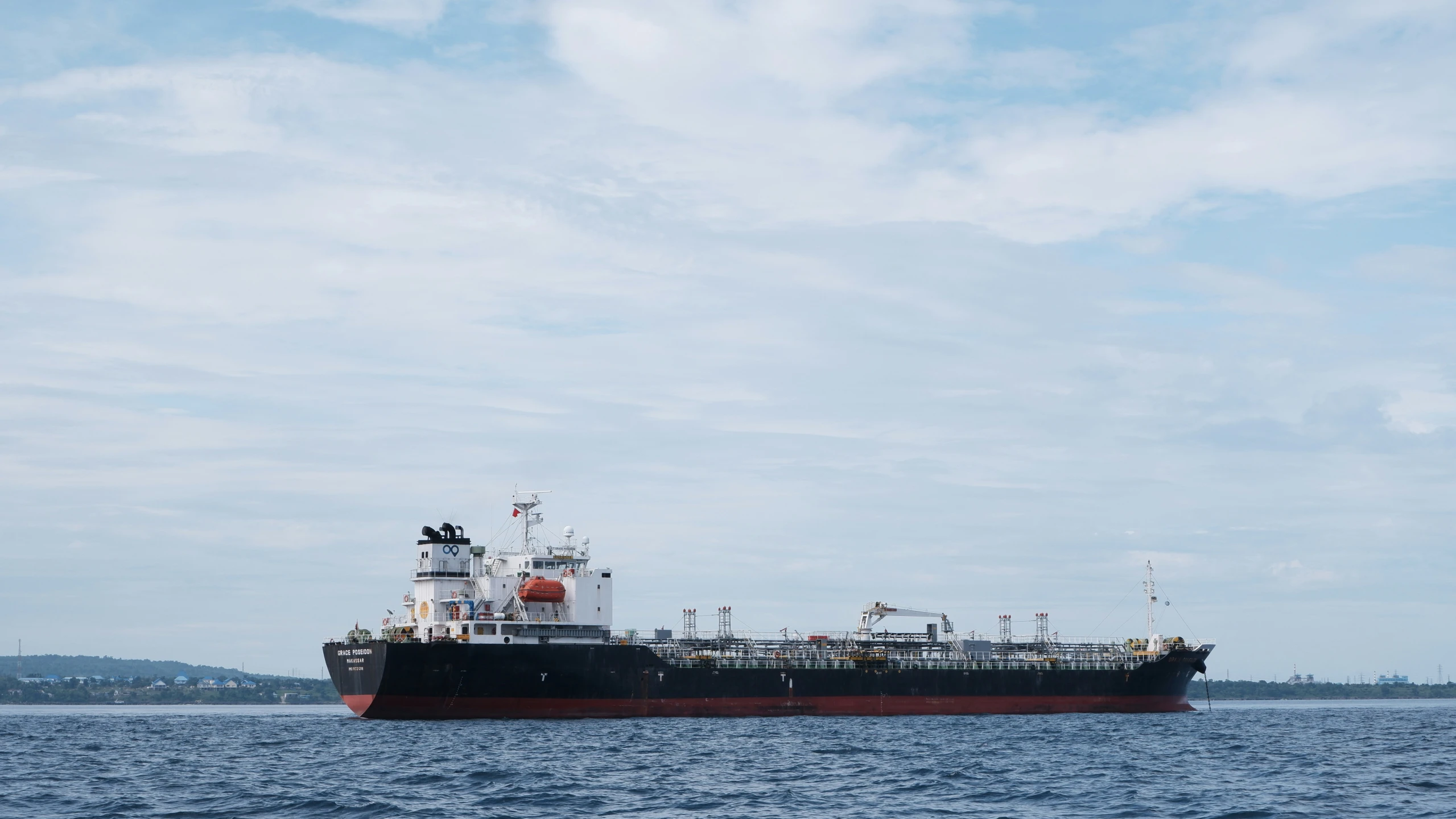 the large boat is anchored at the beach