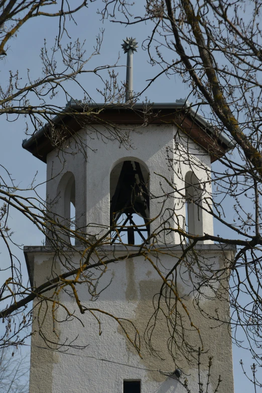 a small bell tower with a clock in the middle
