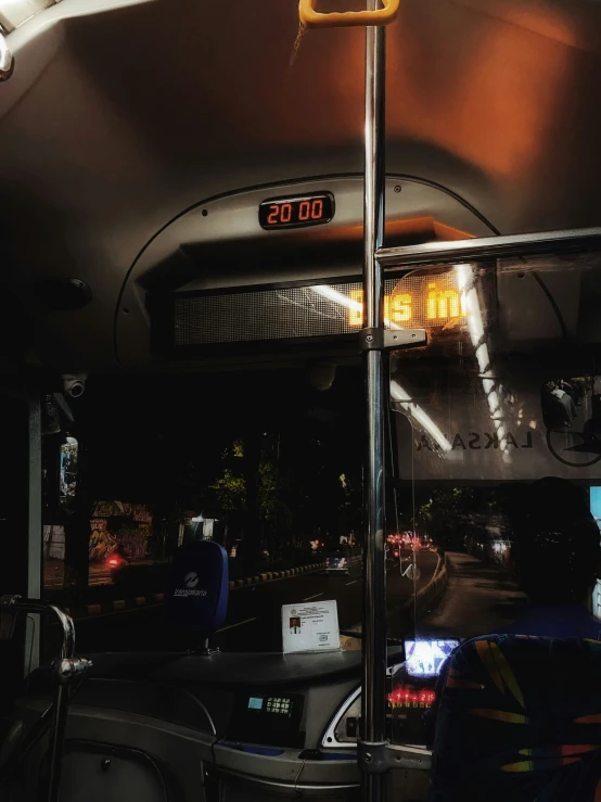 a bus at night with lights on and the door opened