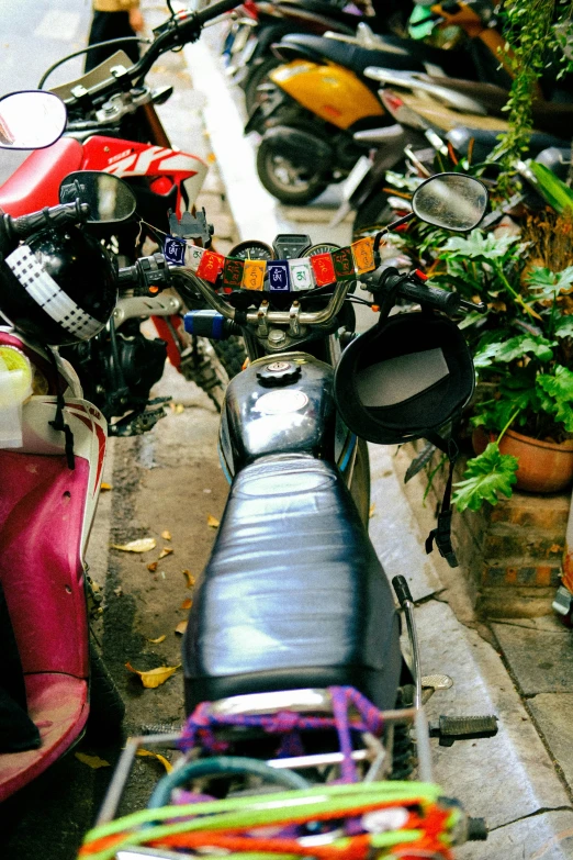 a motor scooter and a couple of people with motorcycles