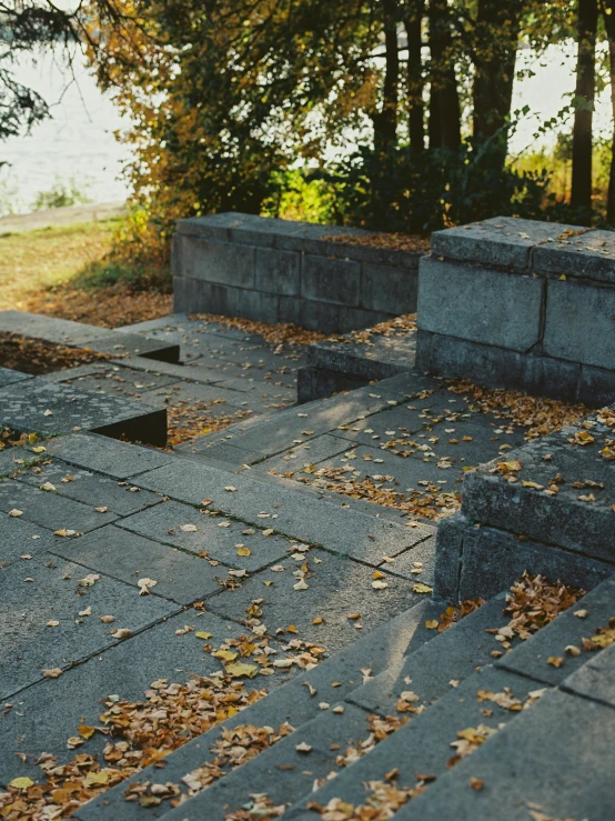 some cement benches and steps with leaves on them