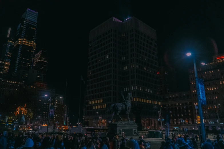 a group of people stand outside at night