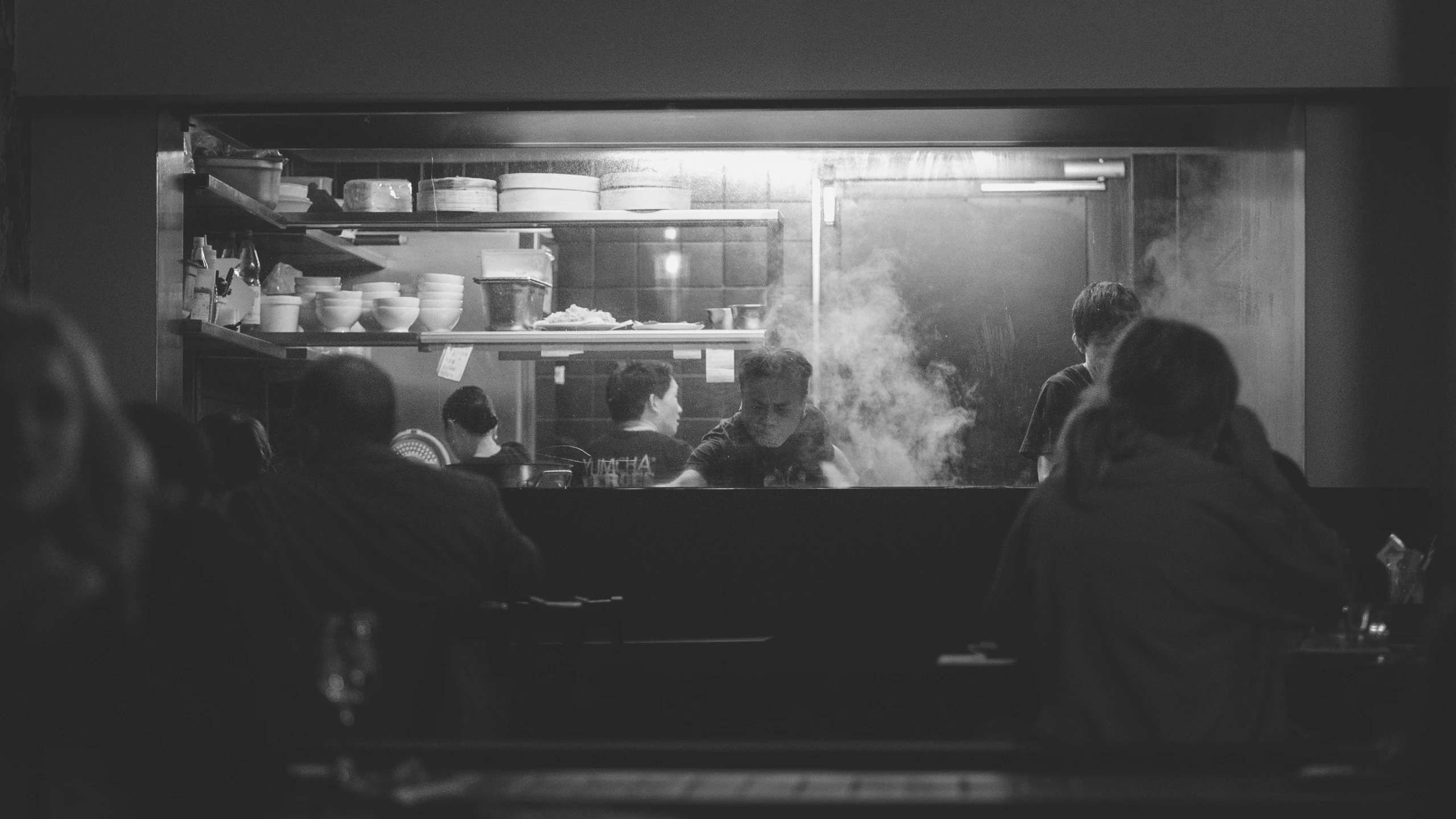 a person in front of a glass filled with smoke