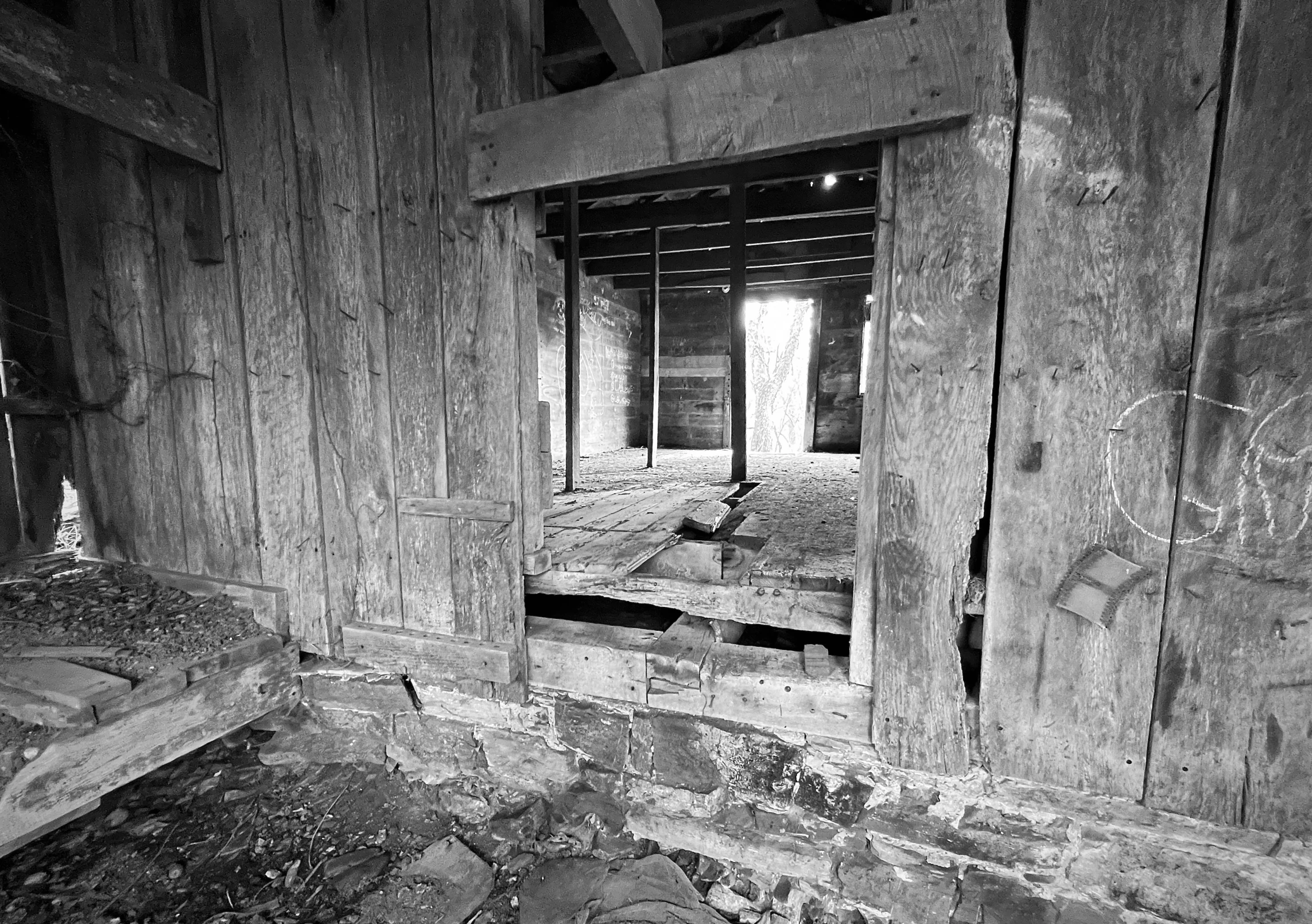 the interior of an abandoned cabin with unfinished wood and rocks