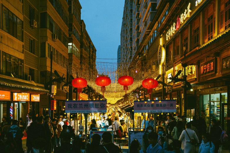 people walking down a crowded street at night