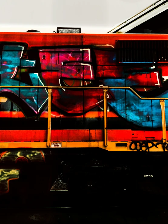 a side view of a train with graffiti