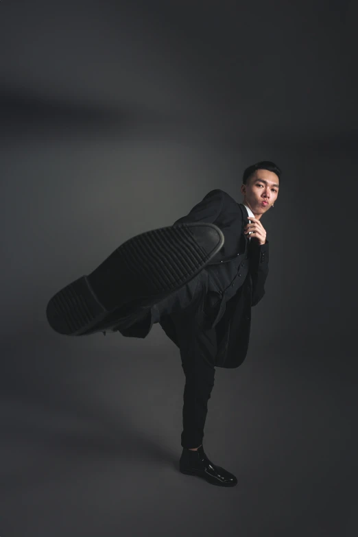 a man holding up a suitcase in the air