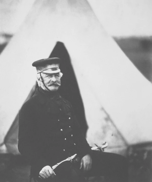 a man with a large gun stands in front of a tent