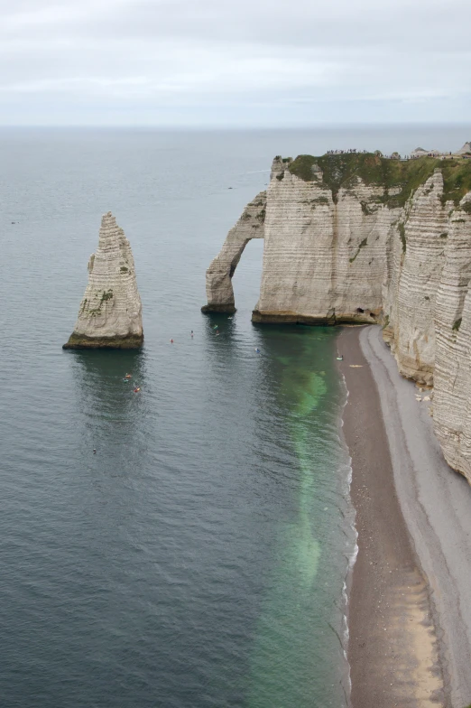 three massive natural rocks sticking out of the water