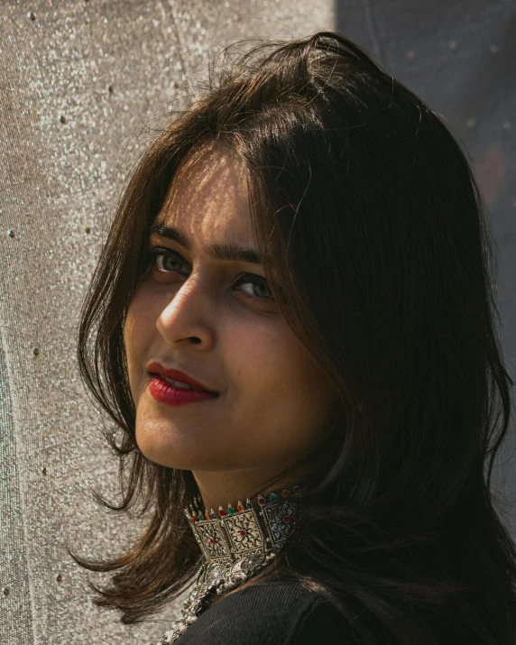 a woman is posing for the camera and looking back