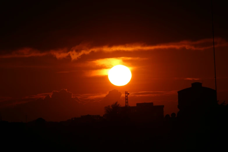 the sun is shining bright with clouds in the sky