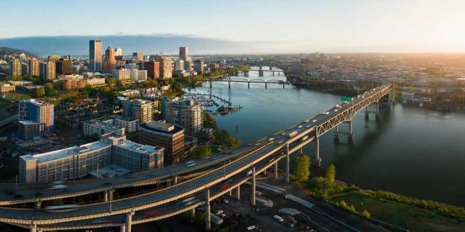 an aerial view of a bridge and city near a body of water