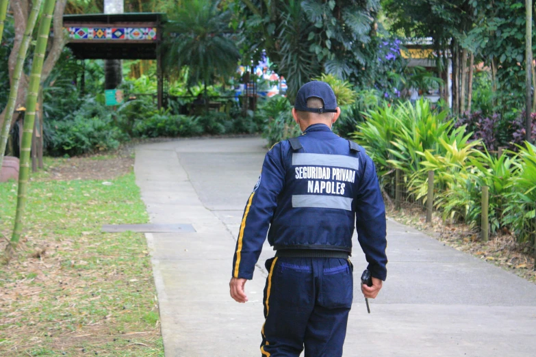 a man walking on the sidewalk wearing a police uniform